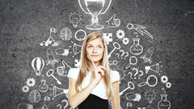 Thoughtful businesswoman standing against concrete wall with winner's cup and business icons sketch. Business leader concept