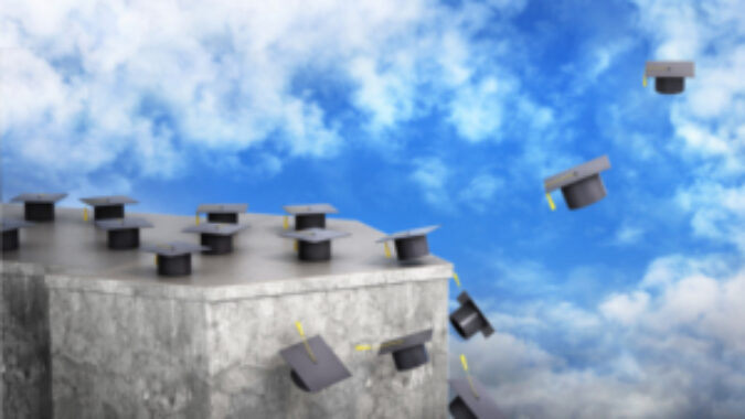 graduation caps flying from a slab of stone into the air.