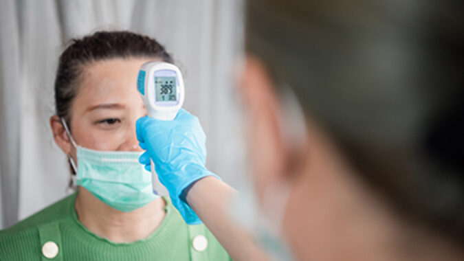 photo of temperature screening an employee at the workplace