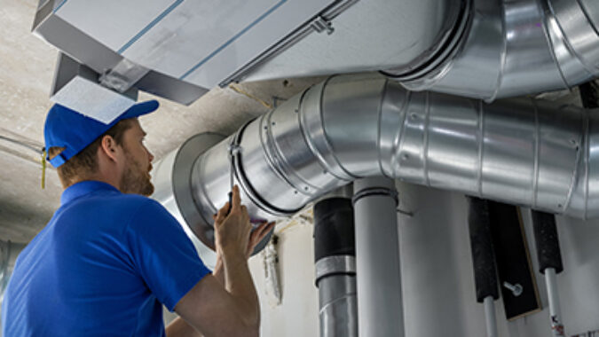 hvac worker install ducted pipe system