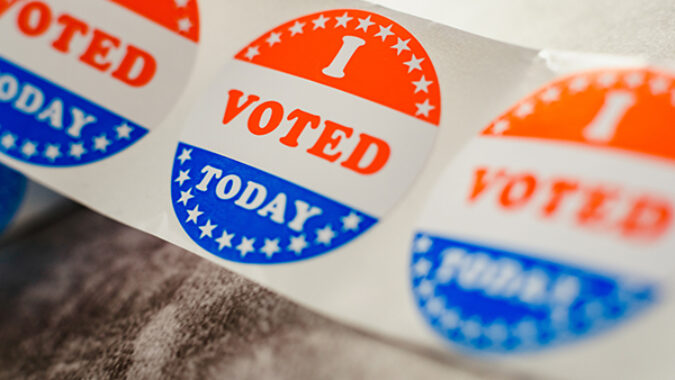 Roll of "I voted" circular stickers on a gray background for the November elections